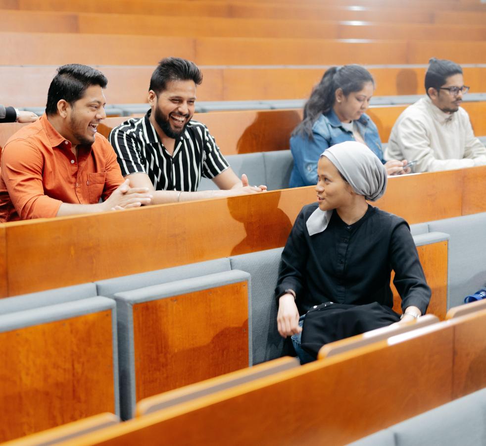Students and researcher in an auditorium