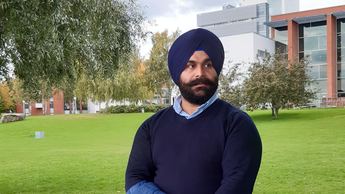 Manmeet standing in the campus park