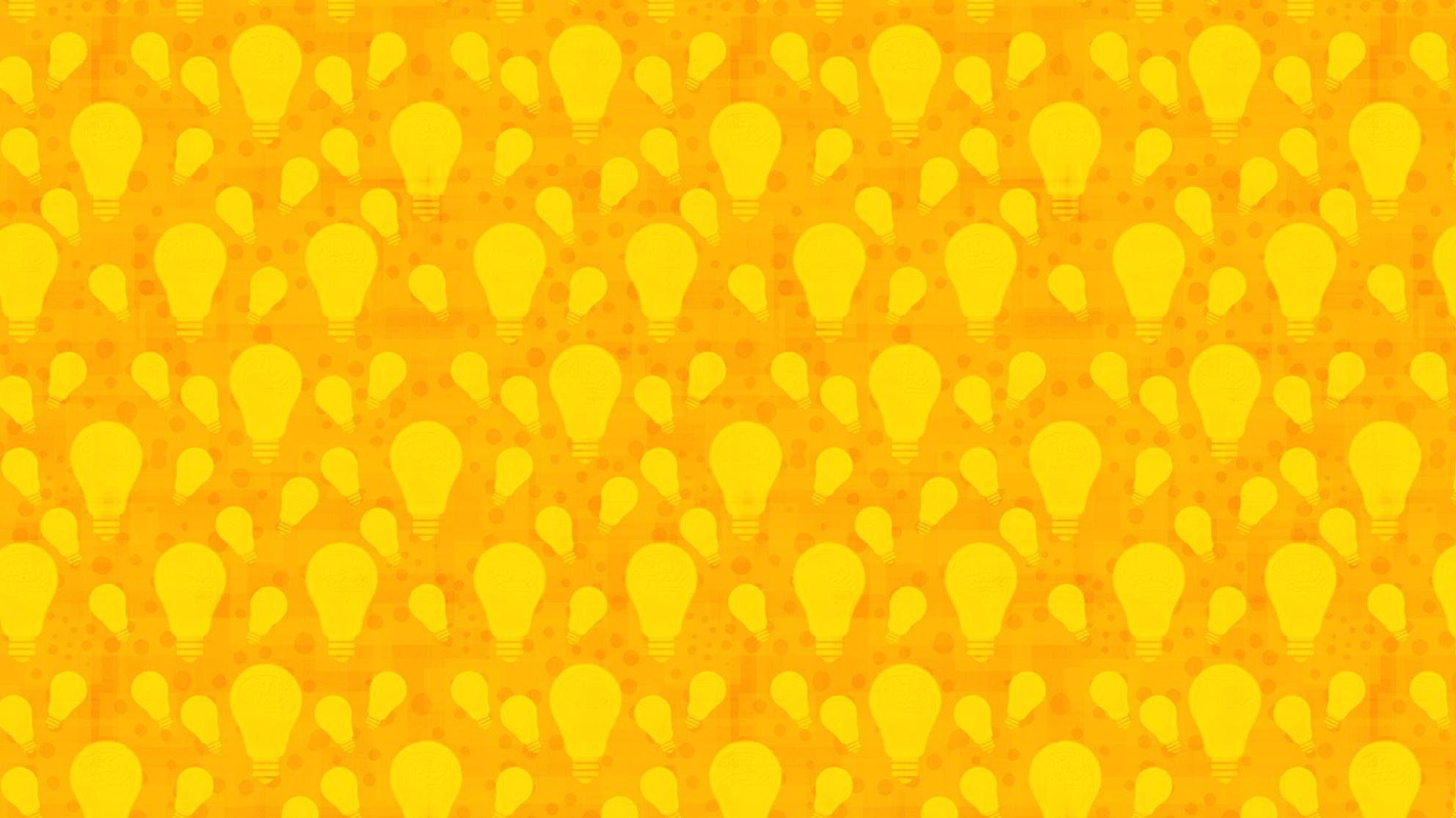 Keltaisia hehkulamppuja oranssilla pohjalla