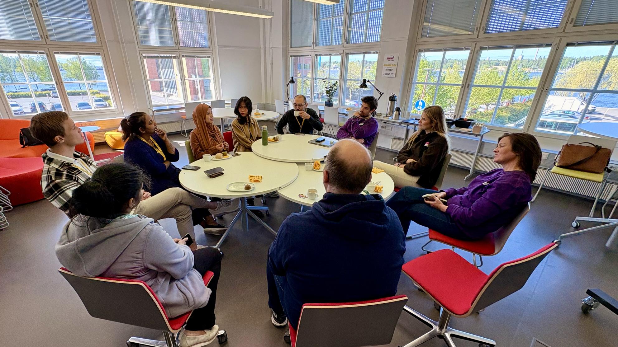 Group picture of the inaugural VSF members breakfast. Several people sitting around round tables, enjoying breakfast and conversation. 