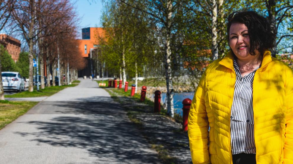 Olena Maslyukivska standing outisde during a sunny spring day