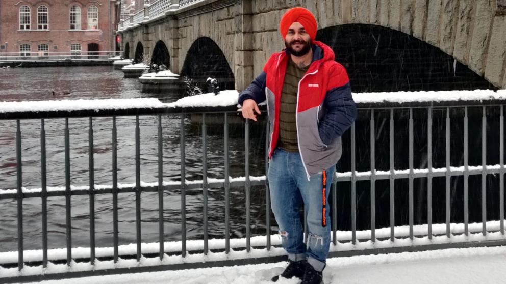 Manmeet posing in the snow in front of old Tampere
