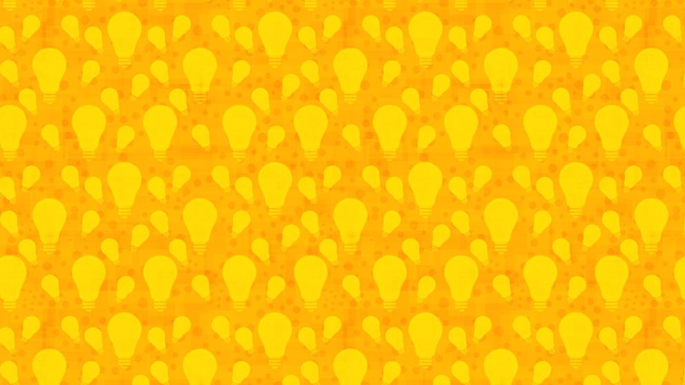 Keltaisia hehkulamppuja oranssilla pohjalla