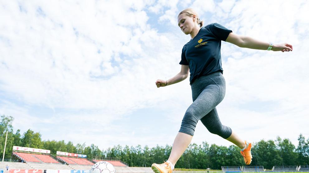 Lady kicking a soccer ball