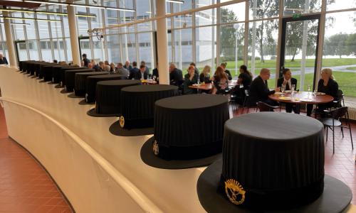 Doctoral hats, people in the background 