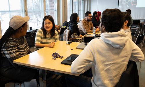 Students discussing around a table