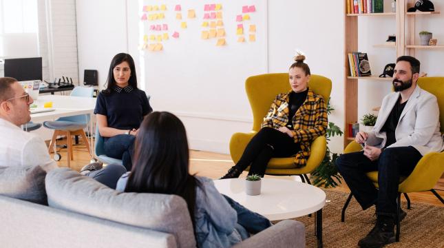 People working sitting on a couch