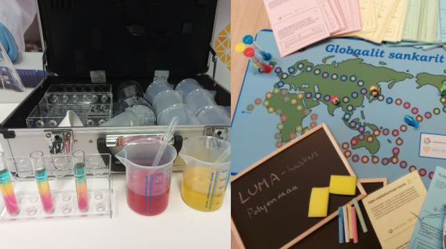 Laboratoriosalkku, jonka edessä astioissa värikkäitä sokeriliuoksia sekä pelilauta nappuloineen ja kysymyskortteineen