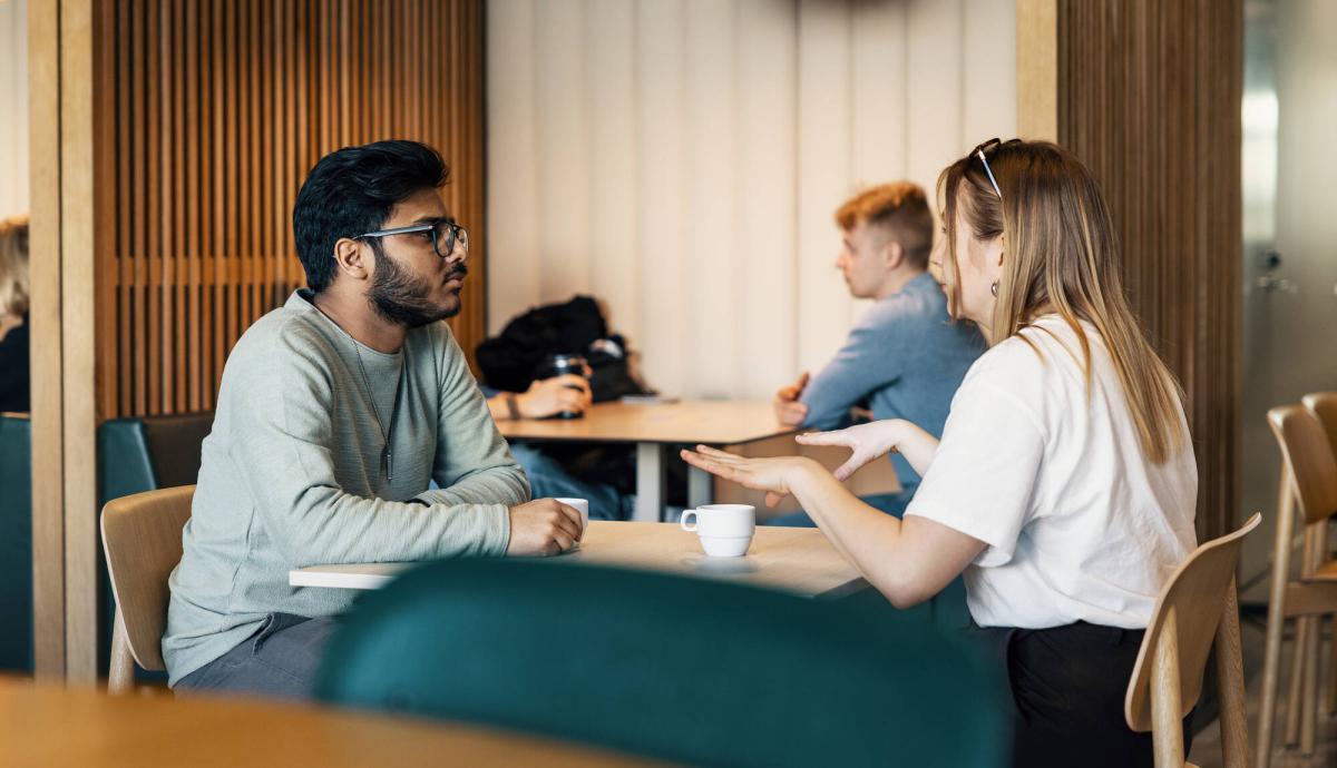 Students discussing at University of Vaasa cafeteria