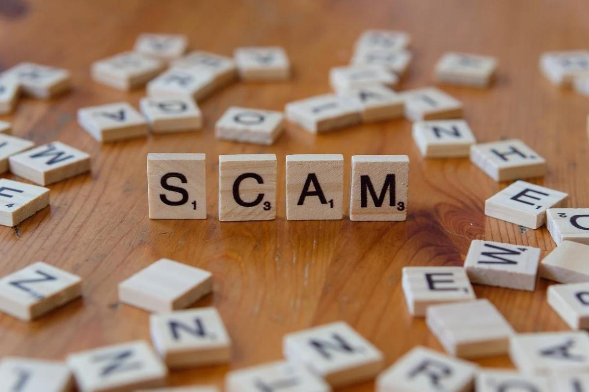 The image illustrates letters of the word scam. 