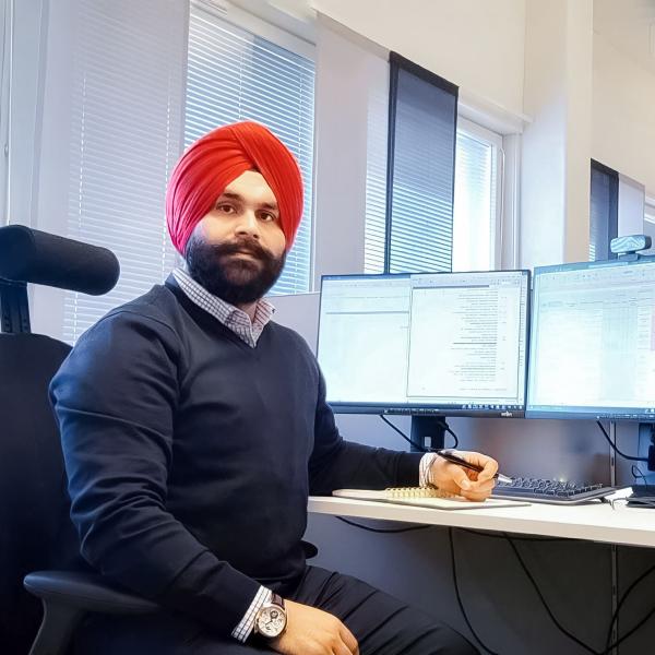 Manmeet sitting at his desk in the Citec office