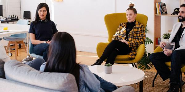 People working sitting on a couch