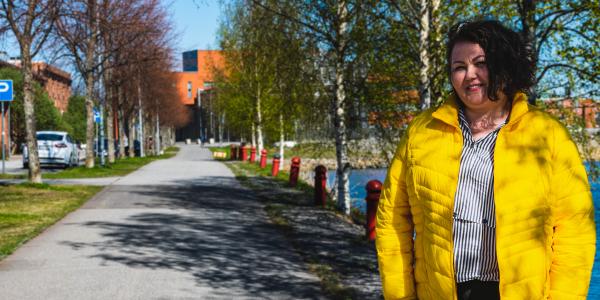 Olena Maslyukivska standing outisde during a sunny spring day