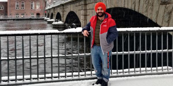 Manmeet posing in the snow in front of old Tampere