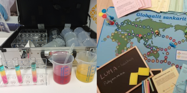 Laboratoriosalkku, jonka edessä astioissa värikkäitä sokeriliuoksia sekä pelilauta nappuloineen ja kysymyskortteineen