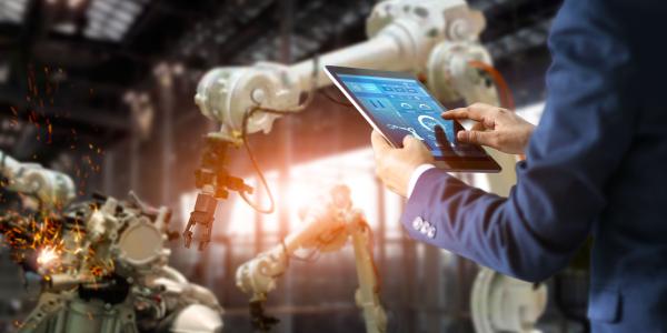 Man with a tablet in a manufacturing environment