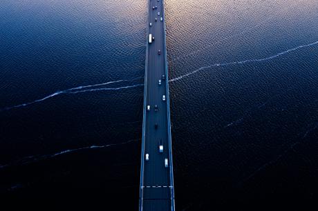 Aerial view of a bridge over a blue sea